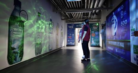 Image is of a corridor showing the different Coca-Cola brands
