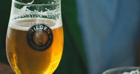 Image shows a glass of Hilden beer with text showing dates 18-20 October and Tickets available soon