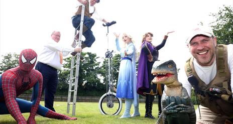 Image shows Characters dressed as princesses and heroes.