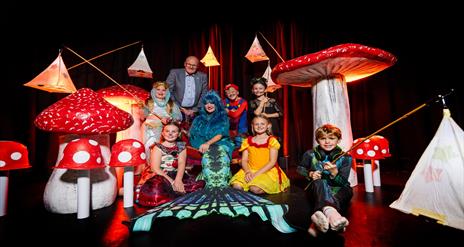 Image is of various children dressed up for Halloween