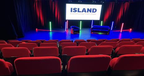 Image is of cinema seats in a small theatre