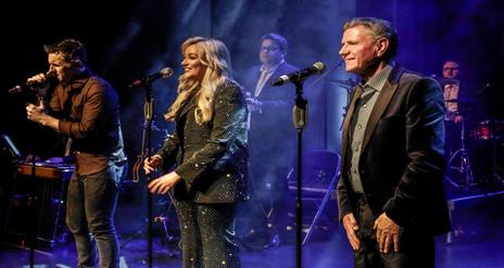 Image is of singers on stage