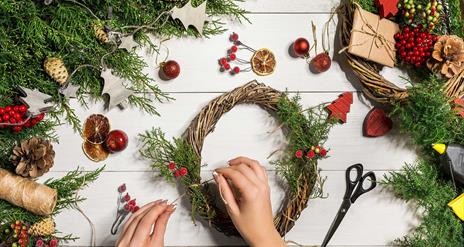 Image is of a Christmas wreath being created