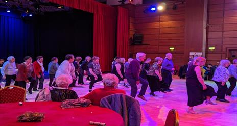 Image is of people dancing on a dance floor