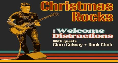 Image is of musician playing an electric guitar on stage