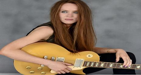 Image is of musician Grainne Duffy with her guitar