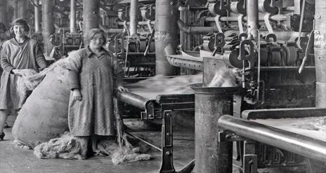 Image is black and white photograph of women working in the Belfast Mills