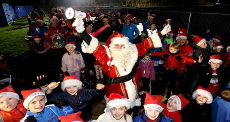 Image is of Santa and participants of the Santa Dash run