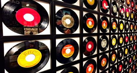 Image is a wall of various vinyl records