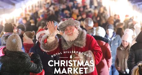Image is of Santa Claus and visitors at the Royal Hillsborough Christmas Market