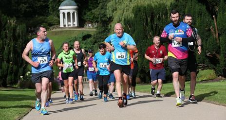Runners running up the hill with Lady Alice's Temple in the background