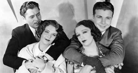 Black and white photo from movie 42nd Street 2 men hugging 2 women