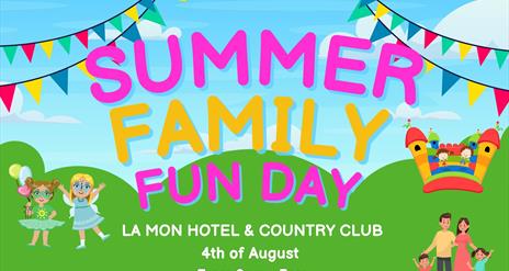 Image is of the Summer Family Fun Day at La Mon Hotel showing rainbow flags, a bouncy castle and cartoon people