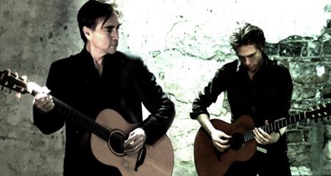 Two men playing guitar