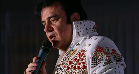 Image is of Elvis personator Jim Brown on stage