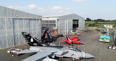 image is of various planes at the Ulster Aviation Society