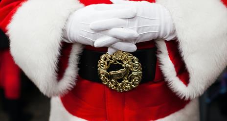 An image of Santa with his hands crossed over his stomach