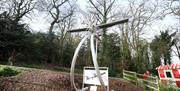 An image of Harry Ferguson Sculpture set within the forest park and makes up part of the digital sculpture trail.