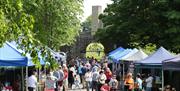 Image shows various people visiting the food stalls on the Dark Walk