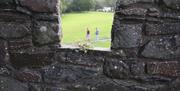 An image taken from the walls of the fort with two people walking in the background