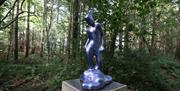 An image of the Magic Garden, which is a figure on top of a plinth set with the forest park and forms part of the Digital Sculpture Trail.