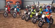 Image shows row of children on mini motorcycles