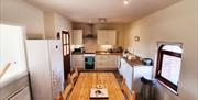 Image shows kitchen area with dining table and 6 chairs
