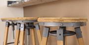 Image shows 2 wooden kitchen stools