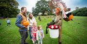 Family looking at scarecrow in grounds of Hillsborough Castle & Gardens