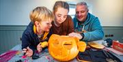 Family carving a pumpkin