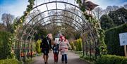 Family walking through the gardens at Hillsborough Castle at Christmas time