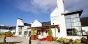 Image shows front of hotel and entrance