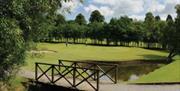 image of gold course hole with brdge