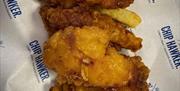 A portion of Chicken gougons on chips from the Chip Hawker
