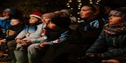 Image shows children listening to a Christmas Story.