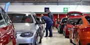Image is of visitors and various types of cars at the Dubshed show at Eikon Exhibition Centre