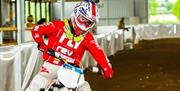 Image shows male racing a motorcycle on the course