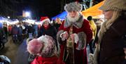 Santa doing a magic trick for a child