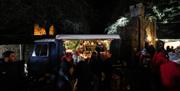 A market trader lit up at the Royal Hillsborough Farmers Market