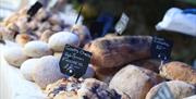Image shows a stall with various breads on offer at the market