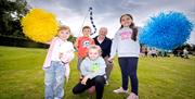 Councillor Tim Mitchell, Chair of our Communities and Wellbeing Committee pictured with local children enjoying last year's Park Life events.