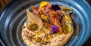 A big plate with food served at Hinch Brasserie