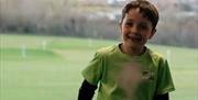 Image is of a small boy at Laganview Golf Centre
