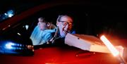 Image is of person holding pizza box in a car at Let's Go Hydro drive-in