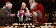 Santa choosing a bun at Dundonald Christmas Market