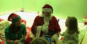 Image is of  little child meeting Santa at High Rise Sensory evening