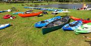 Canoes on land beside the lake