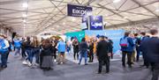 Image is various groups of attendees at the UCAS event in Eikon Exhibition Centre