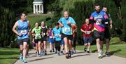 Runners running up the hill with Lady Alice's Temple in the background