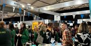 Image shows school children in uniform at exhibition with a range of employers